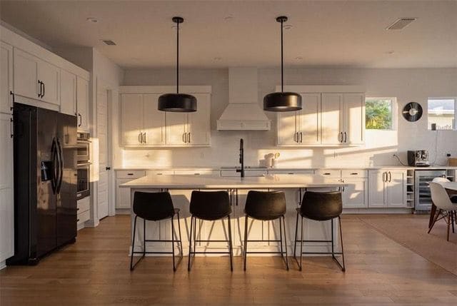 Gourmet kitchen with quartz island and tile backsplash