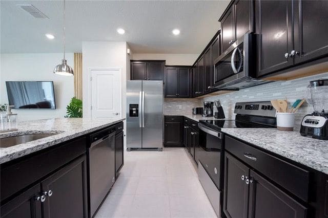 Kitchen with granite counters and stainless appliances